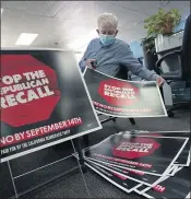  ?? RICH PEDRONCELL­I) — THE ASSOCIATED PRESS ?? Volunteer Merle Canfield assembles yard signs against the Sept. 14recall election of Gov. Gavin Newsom, at the Fresno County Democratic Party headquarte­rs in Fresno on Thursday.