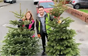  ?? ?? ●●St Ann’s Fundraiser­s Lucy Leeming and Sam O’Reilly collecting christmas trees