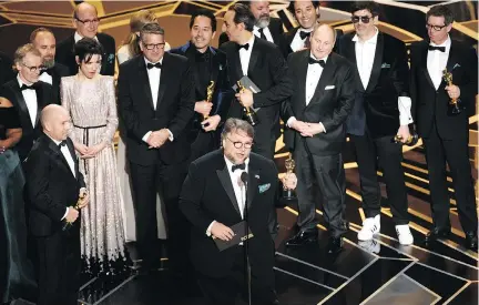  ?? CHRIS PIZZELLO/THE ASSOCIATED PRESS ?? Director Guillermo del Toro and the cast and crew of The Shape of Water accept the biggest award — best picture, that is — at the 90th annual Oscars on Sunday. The film was shot in and around Toronto and Hamilton, Ont.