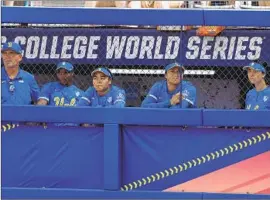  ?? Alonzo Adams Associated Press ?? BRUINS watch from their dugout during the fifth inning as UCLA is routed by No. 1 Oklahoma in the Women’s College World Series semifinal eliminatio­n game.
