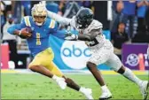  ?? Luis Sinco Los Angeles Times ?? DORIAN THOMPSON-ROBINSON, chased by Oregon’s Vernon McKinley III, has big 2022 goals.