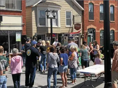  ?? NICHOLAS BUONANNO — NBUONANNO@TROYRECORD.COM ?? People listen to music from Spancil Hill on Saturday during the fourth annual Spring Fest on Remsen Street in downtown Cohoes.
