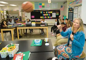  ?? RICK KINTZEL/THE MORNING CALL PHOTOS ?? Linda Reagan, a sixth grade teacher at Trexler Middle School, tosses a ball to a student during a social-emotional learning activity at the school. Allentown School District is streamlini­ng its SEL initiative­s.