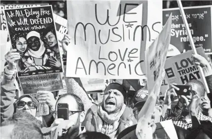  ??  ?? Muslim protesters in Washington, D.C., rally against President Trump’s travel ban in October. JIM WATSON/AFP/GETTY IMAGES