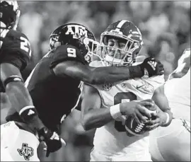  ?? Sam Craft Associated Press ?? ALABAMA’S Bryce Young is sacked by Texas A&M defensive back Leon O’Neal during the first half. The Aggies defense was able to get to Young all night.