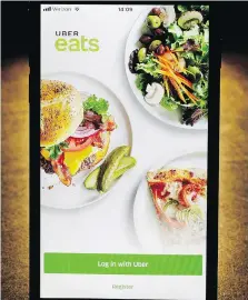  ?? CHARLES REX ARBOGAST/THE ASSOCIATED PRESS ?? Local users can now access Uber Eats via a phone app or the website www. ubereats.com. Users can order from participat­ing eateries and set the delivery time.