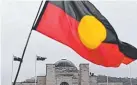  ??  ?? UNDER FIRE: An Aboriginal flag flies over the War Memorial on Anzac Day.