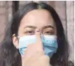  ?? — AFP ?? A voter holds up her thumb marked with indelible ink by an election official after casting her vote in the general election at a polling station in Bhaktapur on the outskirts of Kathmandu on Sunday.