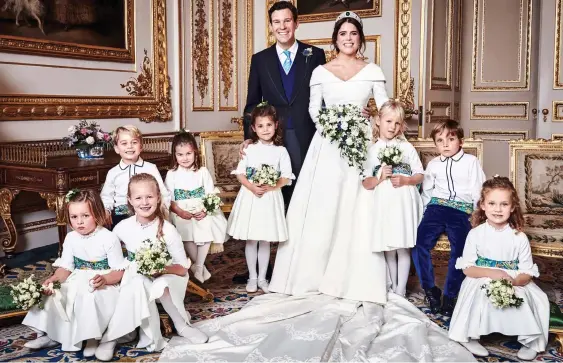  ??  ?? OUR SMILING ANGELS: Jack and Eugenie beam with delight as they pose for the camera in the White Drawing Room with their bridesmaid­s and pageboys