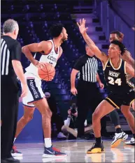  ?? Craig Lenihan / Bahamas Visual Services via AP ?? UConn’s Tyler Polley is guarded by VCU’s Nick Kern (24) at the Battle 4 Atlantis on Friday.