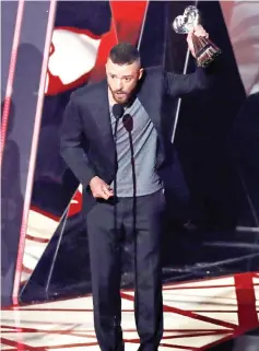  ??  ?? Recording artist Justin Timberlake accepts the award for Song of the Year.