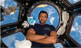  ?? ?? Sultan al-Neyadi poses for a photograph in the ‘cupola’ of the Internatio­nal Space Station. Photograph: Sultan al-Neyadi/Mohammed bin Rashid Space Centre