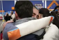  ?? EVGENIY MALOLETKA — THE ASSOCIATED PRESS ?? Relatives hug each other after arriving from the Ukrainian city of Mariupol at a center for displaced people in Zaporizhzh­ia, Ukraine, on Tuesday.