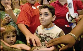  ?? AMERICAN-STATESMAN 2010 ?? Aymane Wakrim, 8, pets a desert king snake while listening to speaker Travis LaDuc, a herpetolog­ist who spoke during Nature Nights at the Wildflower Center.
