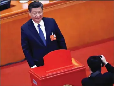  ?? WANG ZHAO/AFP ?? Chinese President Xi Jinping poses for a picture after voting during the third plenary session of the first session of the 13th National People’s Congress at the Great Hall of the People in Beijing yesterday.