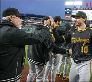 ?? (AP/Alex Brandon) ?? Pittsburgh Pirates Manager Derek Shelton (left) greets outfielder Bryan Reynolds after a 8-4 win over the Washington Nationals on Monday at Nationals Park in Washington. The Pirates are 5-0 to start the season for the first time since 1983.