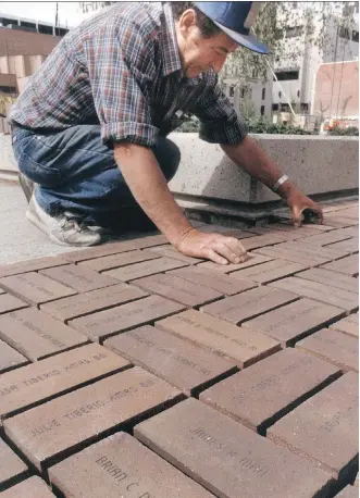  ?? POSTMEDIA NEWS/FILES ?? Pietro Bordin lays personaliz­ed bricks at Olympic Plaza in June, 1987.