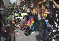  ?? (Joshua Roberts/Reuters) ?? RESCUE WORKERS assist people who were injured when a car driven by James Fields plowed through a group of counterpro­testers at the “Unite the Right” rally in Charlottes­ville, Virginia, on August 12, 2017.