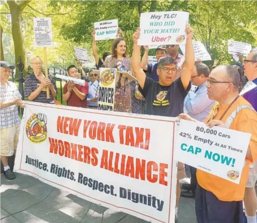  ?? DAN RIVOLI/NEW YORK DAILY NEWS ?? Cab drivers rally outside City Hall on Tuesday to press the City Council to boost their wages and put a cap on app car services.