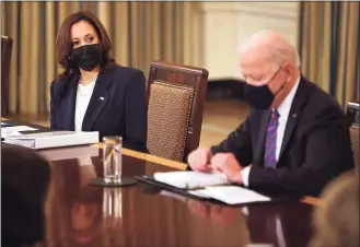  ?? Chip Somodevill­a / TNS ?? Vice President Kamala Harris and President Joe Biden meet with cabinet members and immigratio­n advisers in the State Dining Room on Wednesday. Biden announced that Harris will be leading the White House efforts to handle the crisis at the border.