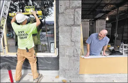  ?? HYOSUB SHIN / HSHIN@AJC.COM ?? Once completed, Manuel’s Tavern will occupy a slightly smaller footprint than before, but Brian (right) contends it will retain the same ambiance.