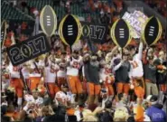  ?? CHRIS O’MEARA — THE ASSOCIATED PRESS ?? Clemson players celebrate after the NCAA college football playoff championsh­ip game against Alabama in Tampa, Fla. Clemson won 35-31.