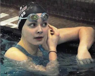  ?? JON BEHM — THE MORNING JOURNAL ?? Rocky River junior Katherine Burgess checks the scoreboard for her time following her 100 breaststro­ke swim at the Division I state meet on Feb. 24. Burgess finished 15th win a time of 1:06.53.