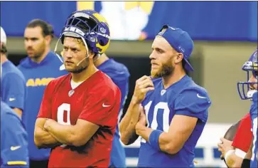  ?? Marcio Jose Sanchez Associated Press ?? NEW RAMS quarterbac­k Matthew Stafford, left, stands with receiver Cooper Kupp during a practice June 10 at SoFi Stadium. Stafford would benefit from a solid running game, something his Lions teams usually lacked.