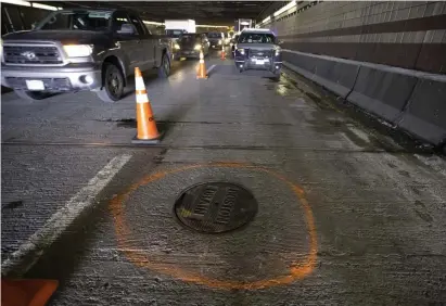  ?? BOSTON HERALD FILE PHOTOS ?? SUIT FILED: A replacemen­t manhole cover is seen in 2016 at the site inside the O’Neill Tunnel where a previous cover came loose and smashed through the window of Caitlin Clavette’s vehicle, seen below, killing her.