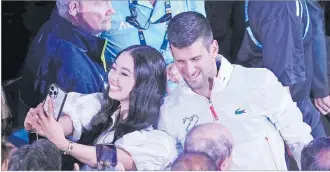  ?? Picture: REUTERS/Sandra Sanders ?? Serbia’s Novak Djokovic takes selfies with fans after winning his final match against Greece’s Stefanos Tsitsipas.