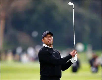  ?? RONALD MARTINEZ — GETTY IMAGES ?? Tiger Woods plays a shot Wednesday during a pro-am prior to The Genesis Invitation­al at Riviera Country Club in Pacific Palisades.