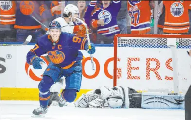  ?? Jeff Mcintosh The Canadian Press via AP ?? Edmonton Oilers center Connor Mcdavid celebrates a Game 7 goal that got by a dejected Los Angeles Kings goalie Jonathan Quick during their first-round series.