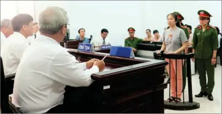  ?? VIETNAM NEWS AGENCY/AFP ?? Vietnamese blogger Nguyen Ngoc Nhu Quynh (second right), also known as ‘Mother Mushroom’, stands trial at a courthouse in the central city of Nha Trang on June 29.