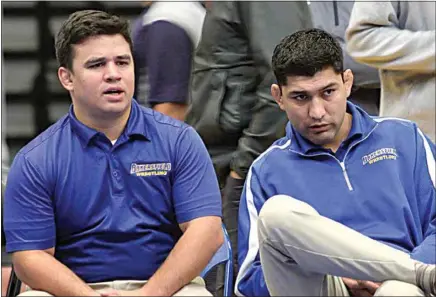  ?? COURTESY OF CSUB ATHLETICS ?? Luke Smith, left, and Manny Rivera oversee a CSUB wrestling match. Smith was selected to lead the program on an interim basis after Rivera stepped down Sept. 24.