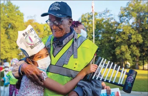  ?? (Ap/news & Record/kenneth Ferriera) ?? A Peck Elementary School student hugs Thomas Faucette, a crossing guard at the school, on Sept. 29 during a celebratio­n in honor of his 100th birthday in Greensboro, N.C.