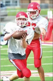  ??  ?? Heber Springs sophomore Spencer Evans catches a pass in front of junior Mason Milner. The Panthers tied Stuttgart for the conference championsh­ip last season.