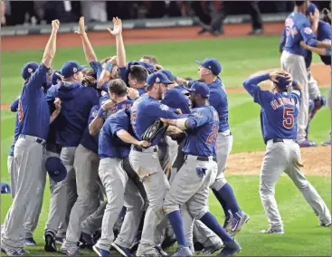  ?? Charlie Riedel/AP ?? Chicago Cubs celebrate after Game 7 of the Major League Baseball World Series against the Cleveland Indians Thursday, Nov. 3, 2016, in Cleveland. The Cubs won 8-7 in 10 innings to win the series 4-3.