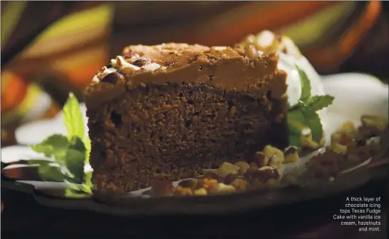  ?? CINDY YAMANAKA — SOUTHERN CALIFORNIA NEWS GROUP ?? A thick layer of chocolate icing tops Texas Fudge Cake with vanilla ice cream, hazelnuts and mint.