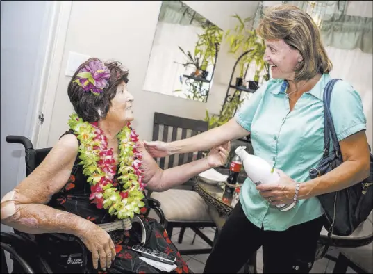  ?? Patrick Connolly Las Vegas Review-Journal @PConnPie ?? Nancy Estocado, program supervisor of physical medicine and rehabilita­tion at Sunrise Hospital, is reunited with Virginia Nixon at Nixon’s house in Kingman, Ariz., on July 9, after she saved Nixon’s life from necrotizin­g fasciitis.