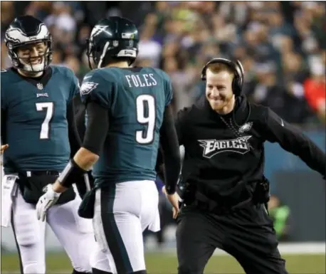  ?? PATRICK SEMANSKY — THE ASSOCIATED PRESS ?? There was plenty of celebratio­n Sunday night for the Eagles’ Carson Wentz, right, and Nick Foles, in a 38-7 pounding of the Vikings. But coach Doug Pederson is ready to get back to work in preparatio­n for the Patriots in Super Bowl LII.