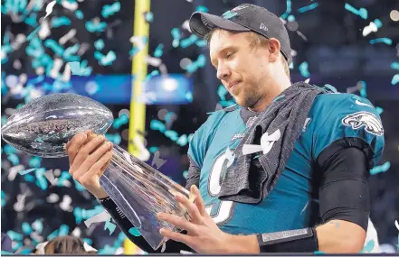  ?? MARK HUMPHREY/ASSOCIATED PRESS ?? The Eagles’ Nick Foles holds the Vince Lombardi Trophy after his team’s win over the Patriots in Sunday’s Super Bowl. Foles led Philadelph­ia to a victory over Tom Brady and New England thanks to a lot of trial and error throughout his football career.