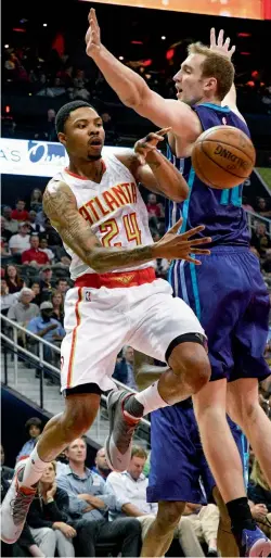  ?? — AP ?? Atlanta Hawks’ Kent Bazemore passes as Charlotte Hornets’ Cody Zeller defends in their game on Tuesday.