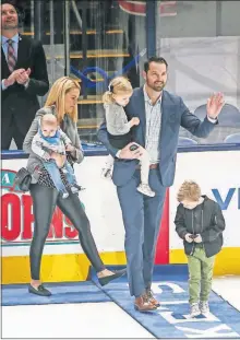  ?? [TYLER SCHANK/DISPATCH] ?? Rick Nash takes the ice with his wife, Jessica, and their children, from left, Finn, Ellie and Mclaren, for the puck drop before the Blue Jackets’ game against the Rangers at Nationwide Arena.