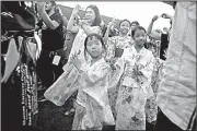  ?? AP/DANIEL CHAN ?? Japanese children in Shah Alam, Malaysia, dance Saturday during the Bon Odori Festival. Participan­ts, mostly Japanese people living in Malaysia, celebrate the summer festival as a way to honor their ancestors.