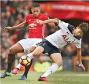  ?? PIC/PTI ?? Manchester United’s Luis Antonio Valencia, left, and Tottenham Hotspur’s Son Heung-min battle for the ball during the Premier League soccer match between Manchester United and Tottenham Hotspur at Old Trafford in Manchester, England, Sunday