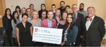  ?? ANDREW FRANCIS WALLACE/TORONTO STAR ?? Torstar Chair John Honderich, far right, and Star acting publisher David Holland, wearing poppy, present Daniele Zanotti, centre, CEO of United Way Toronto and York Region, with a cheque representi­ng Star employee donations.