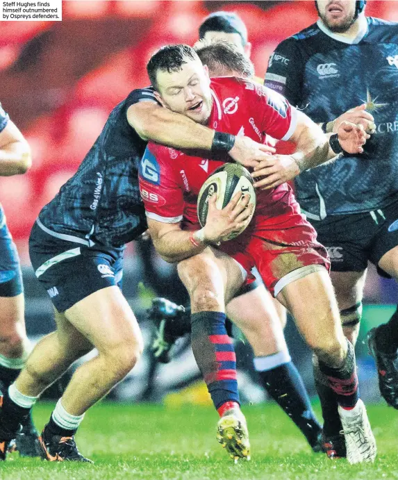  ??  ?? Steff Hughes finds himself outnumbere­d by Ospreys defenders.