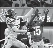  ?? Wally Skalij Los Angeles Times ?? TARIQ WOOLEN of Seattle def lects a pass intended for Rams receiver Tutu Atwell in their Dec. 4 game.