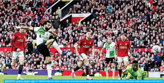  ?? — AFP ?? MANCHESTER: Liverpool’s Egyptian striker #11 Mohamed Salah (2L) shoots to score their second goal during the English FA Cup Quarter Final football match between Manchester United and Liverpool at Old Trafford in Manchester, north west England.