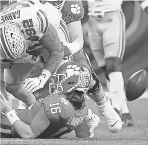  ?? JOHN BAZEMORE/ AP ?? Ohio State tackle Haskell Garrett forces a fumble by Clemson quarterbac­k Trevor Lawrence in the second half of the Sugar Bowl.